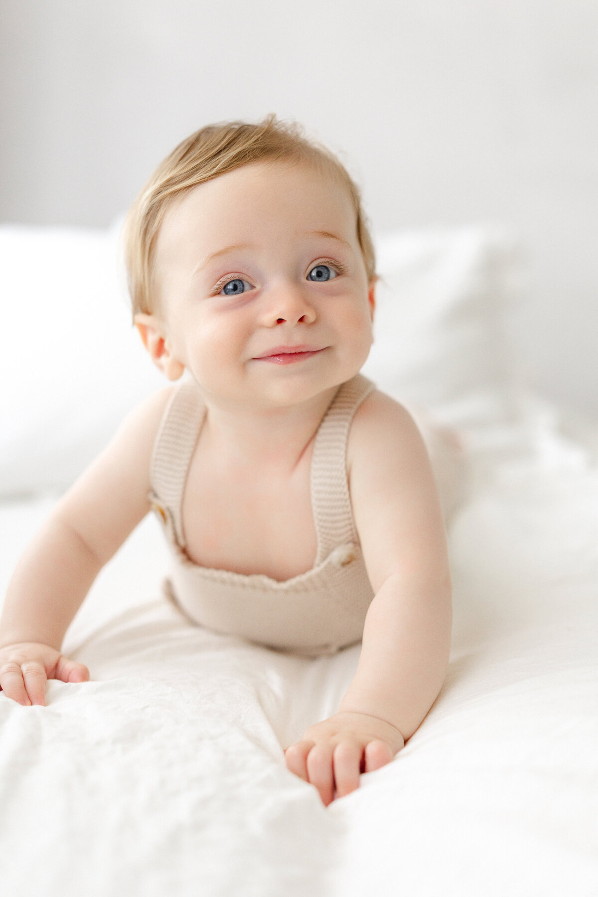 Tampa 6-month milestone portrait of smiling baby boy in natural light studio