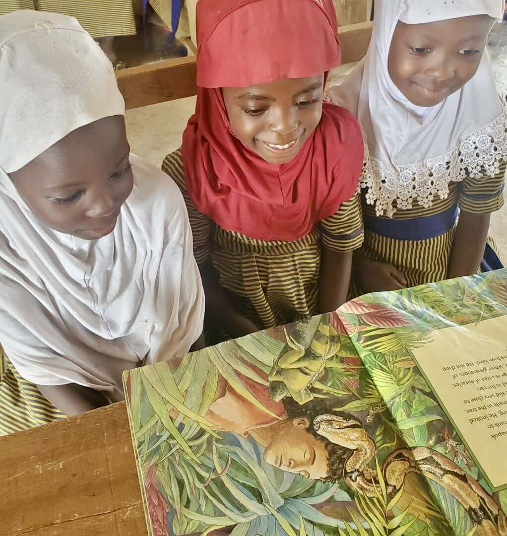 3 girls reading book