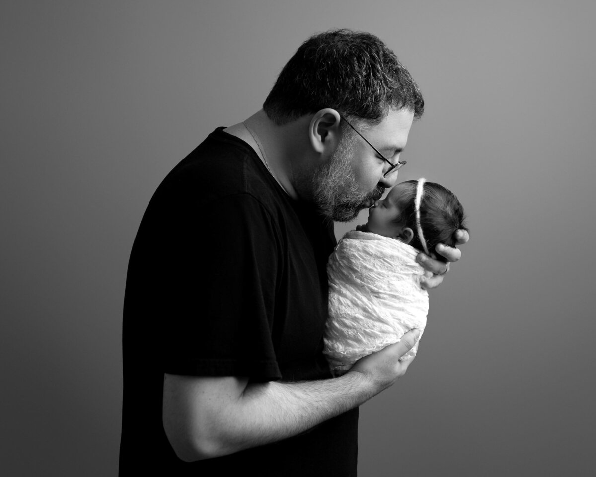 Black white father holding newborn Spanish Oaks artistic family photographer