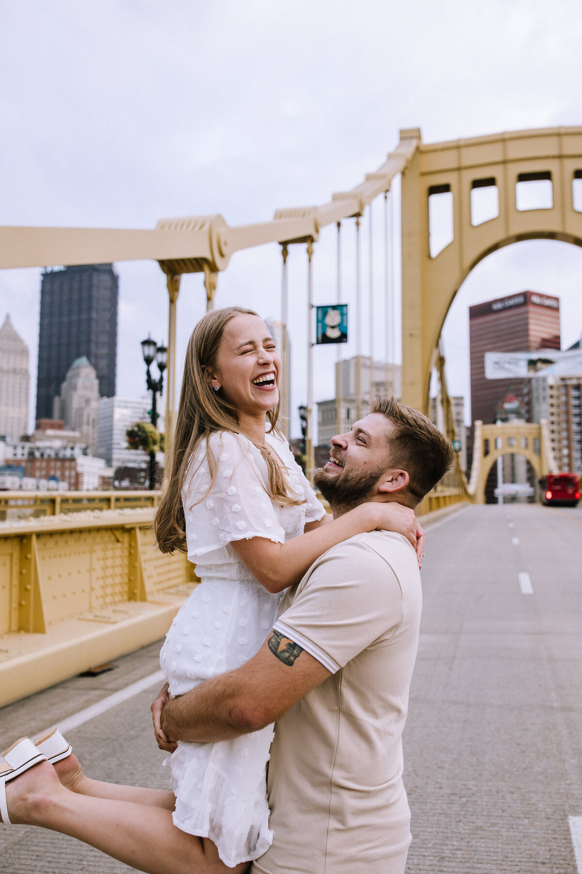 Engaged couple on the Roberto Clemente Bridge. 