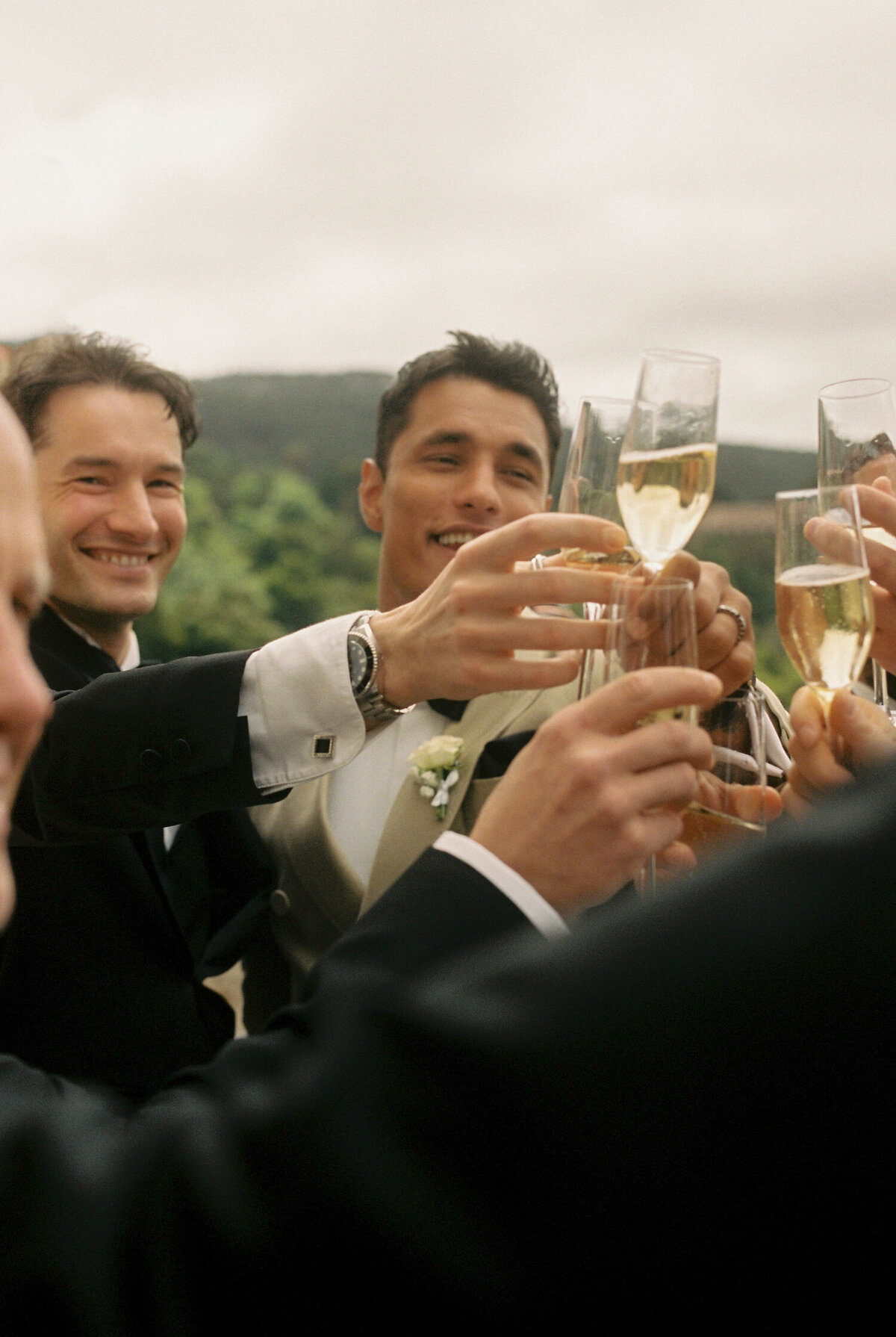 The groom is sharing a happy toast with his groomsmen in his destination wedding in Quinta da Bellavista