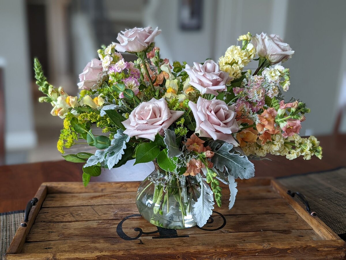 pink funeral flower arrangement in vase