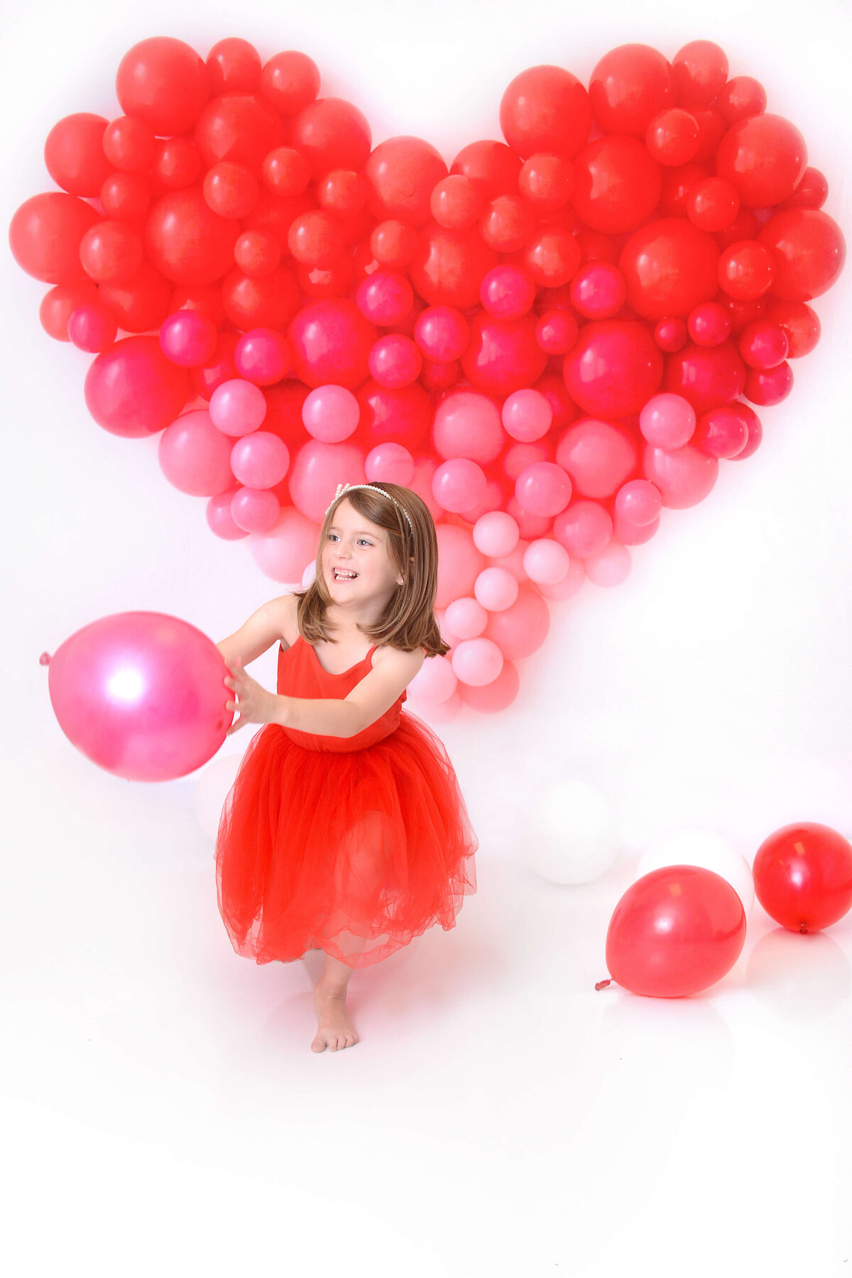 girl smiles at her girly first birthday photoshoot in houston