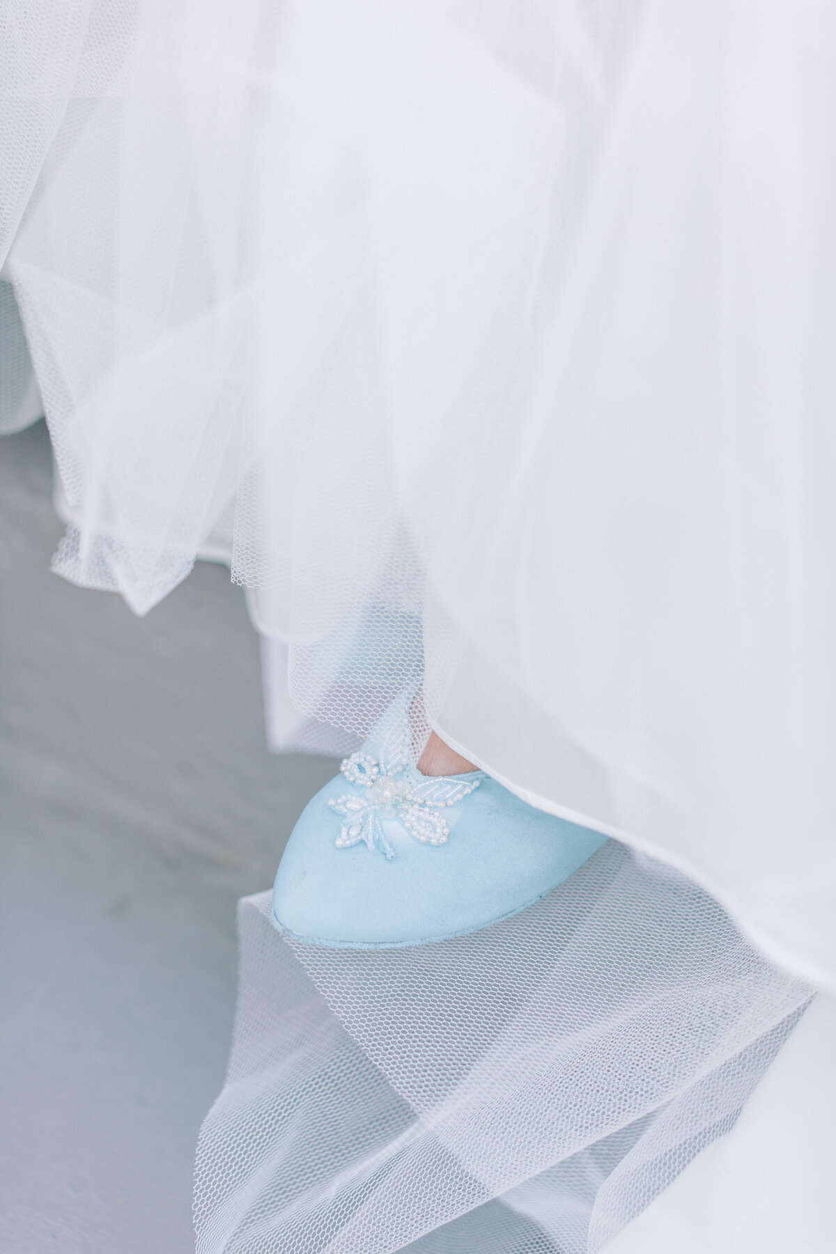 A bride wears a vintage blue shoe.