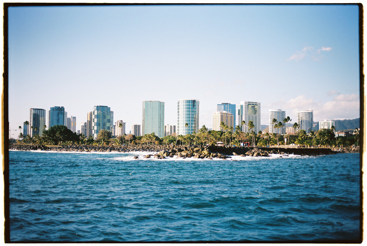 Landscape of Honolulu captured on film by Kate Winters Photography, showcasing the natural beauty and vibrant atmosphere in an authentic, documentary style.