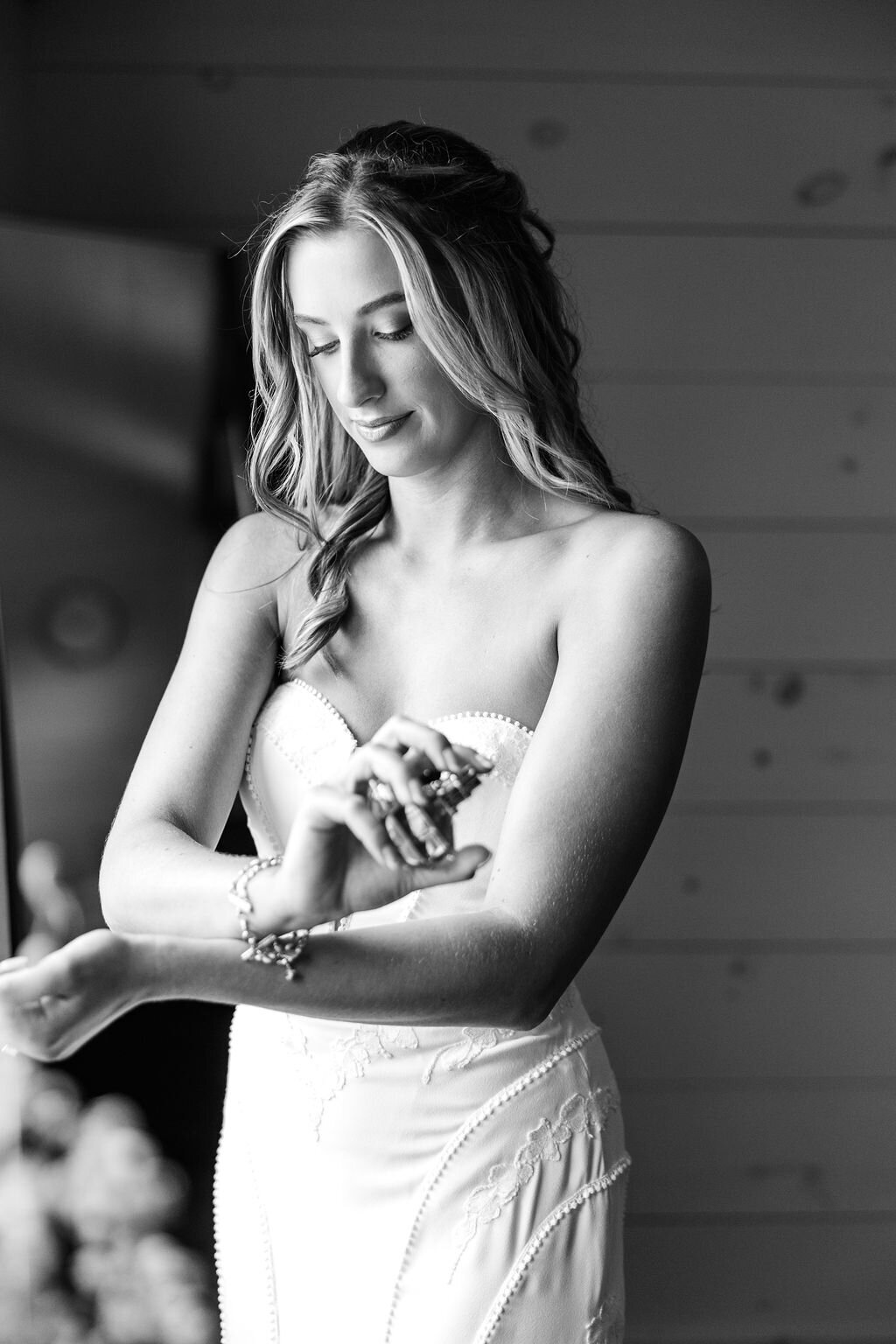 Photo of bride putting on perfume.