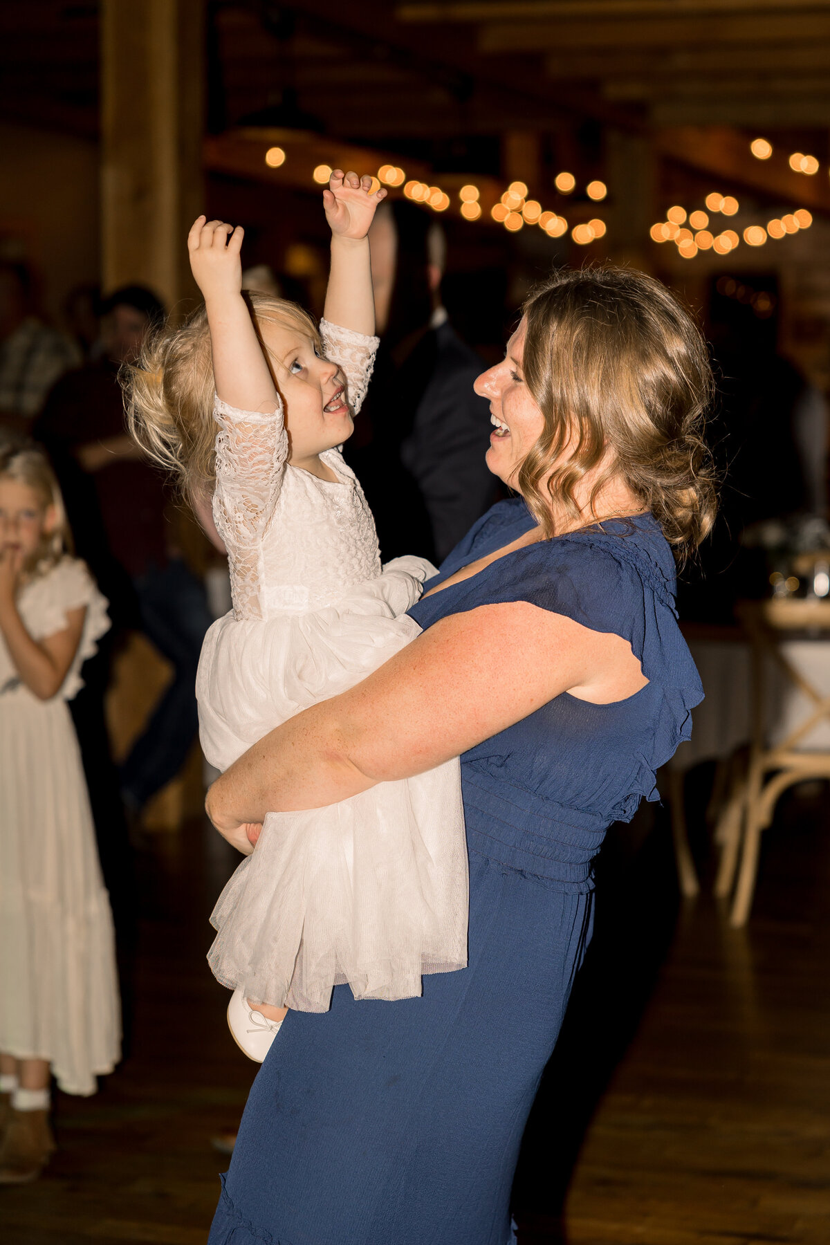 Flower girl with mom on dance floor at wedding reception in Central Minnesota