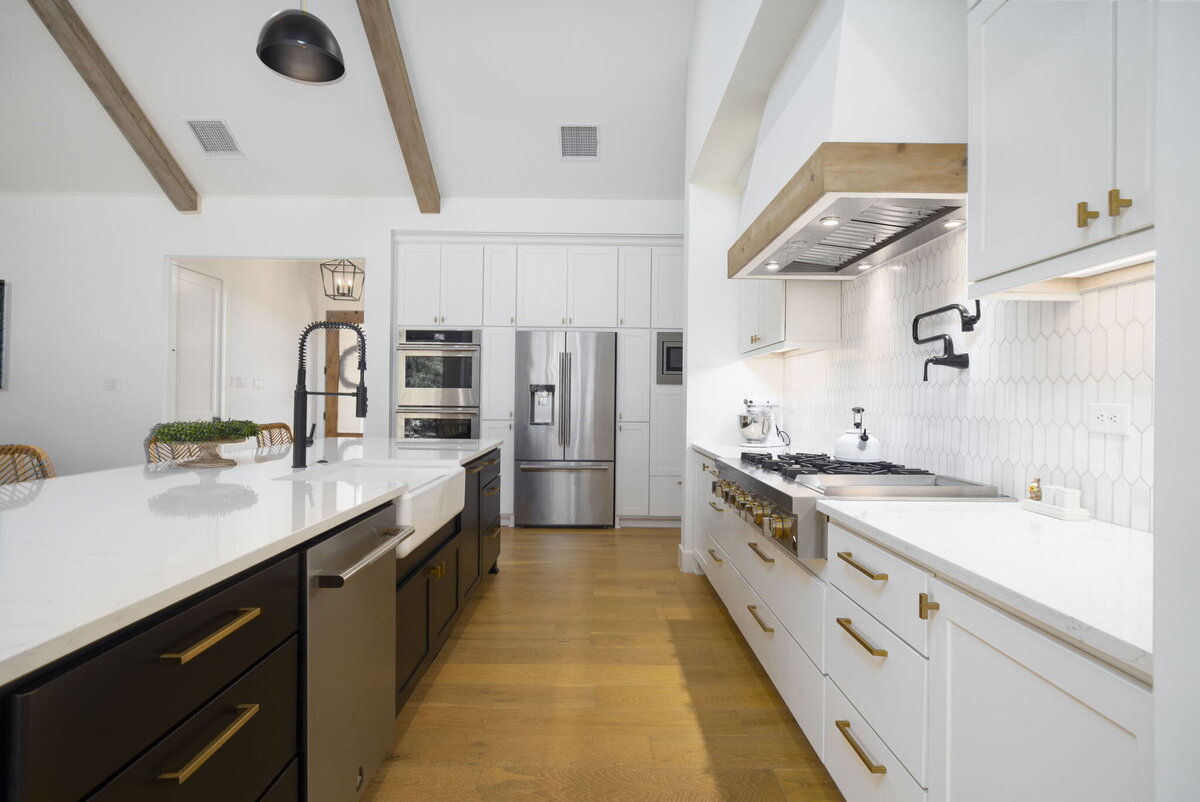 kitchen with white cabinets, gold hardware and wood floors