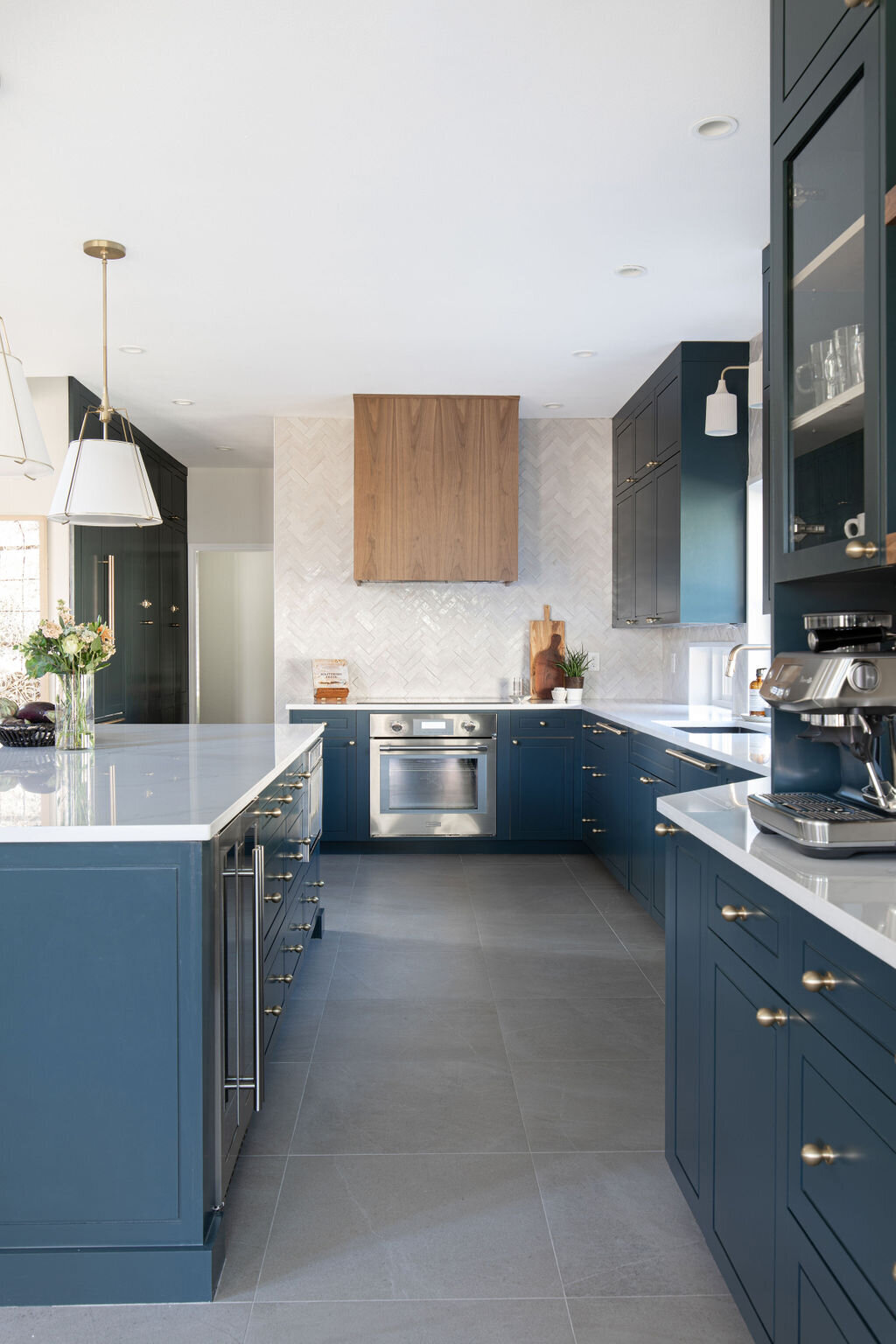 hello-home-austin-contemporary-navy-kitchen-remodel-wood-vent-hood-zelliege-herringbone-backsplash-open-layout-2