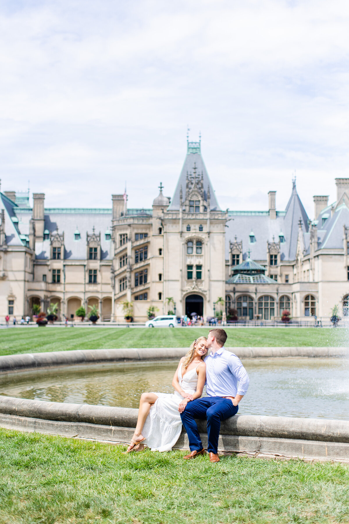engaged couple posing in front of fountain at Biltmore Estate