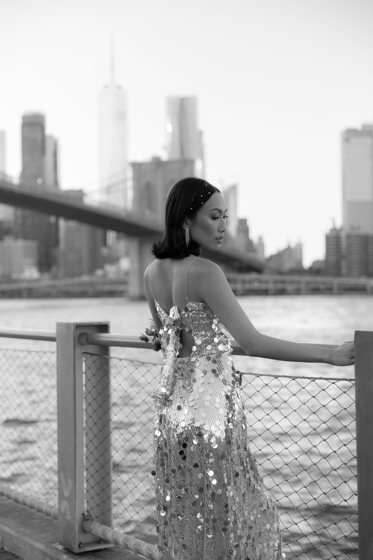 A close-up shot of the bride’s shimmering sequin dress as it catches the light under the bridge.