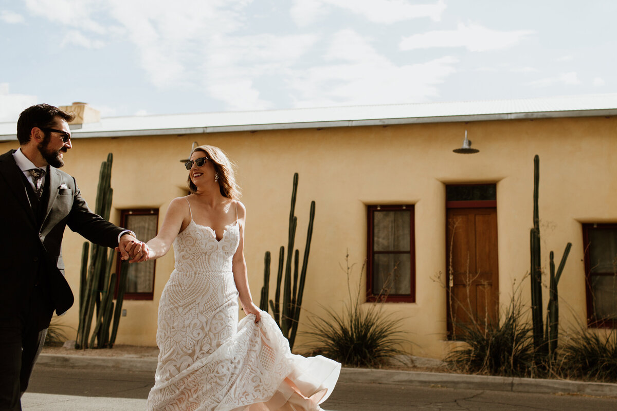 A fun candid moment of a couple walking in the streets of Tucson captured by Fort Worth Wedding Photographer, Megan Christine Studio