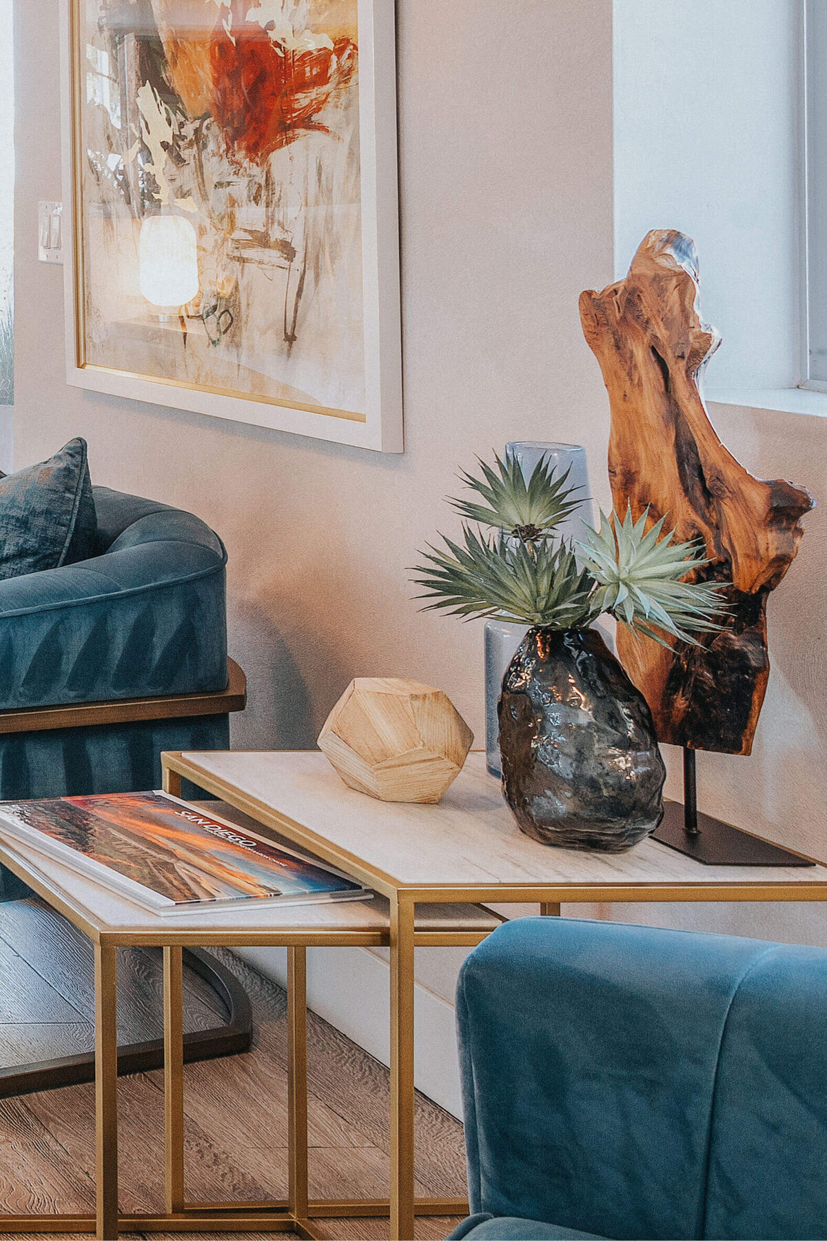Cozy lounge at Sunterra in Oceanside featuring blue chairs, abstract art, and a modern office space.