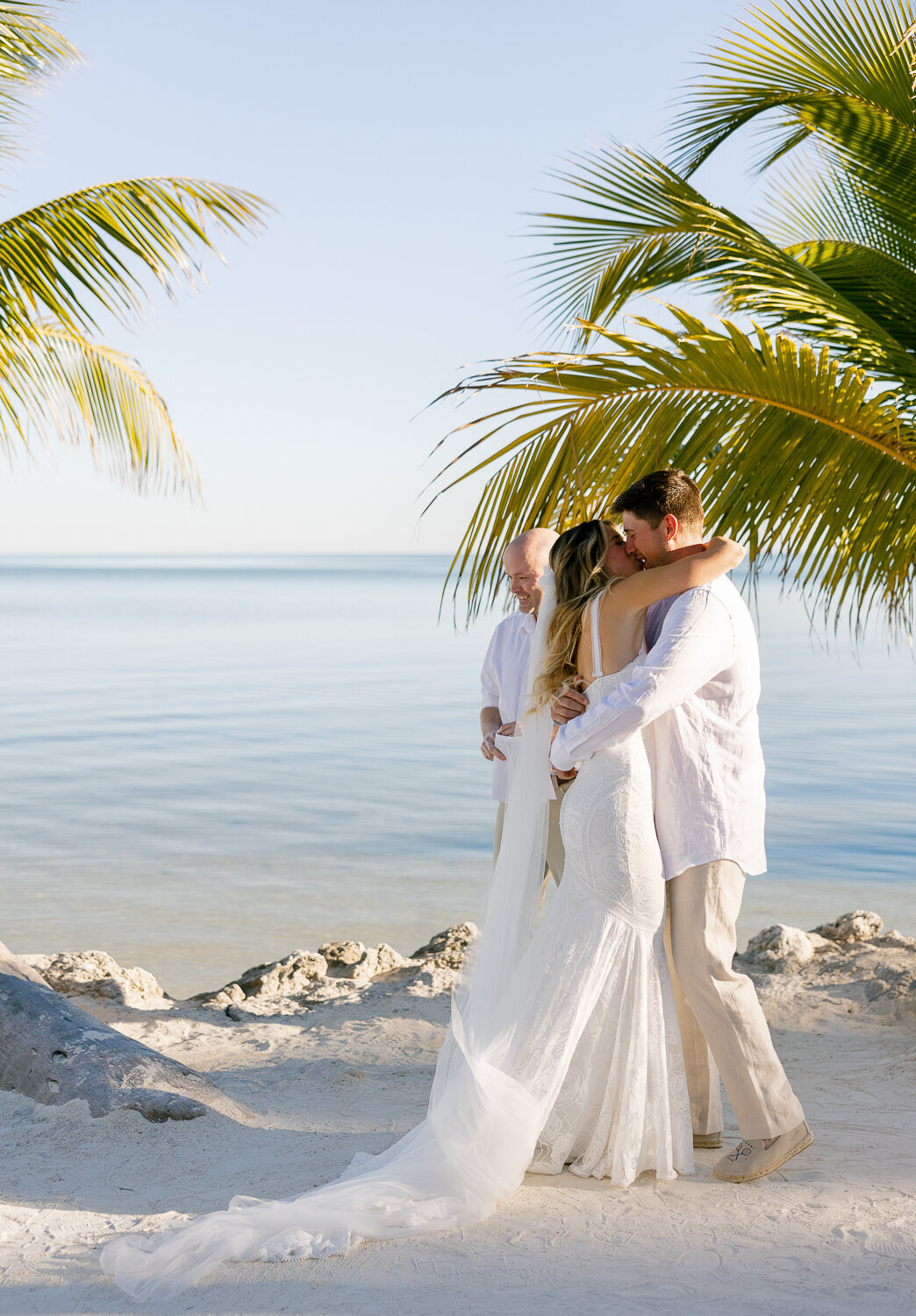 Bride and groom sharing a quiet moment under the palm trees at their elegant Cheeca Lodge Resort wedding.
