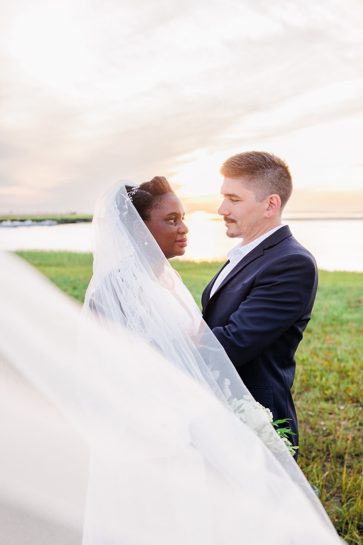 Bride and groom hugging on Gray's Beach representing Cape Cod wedding photography