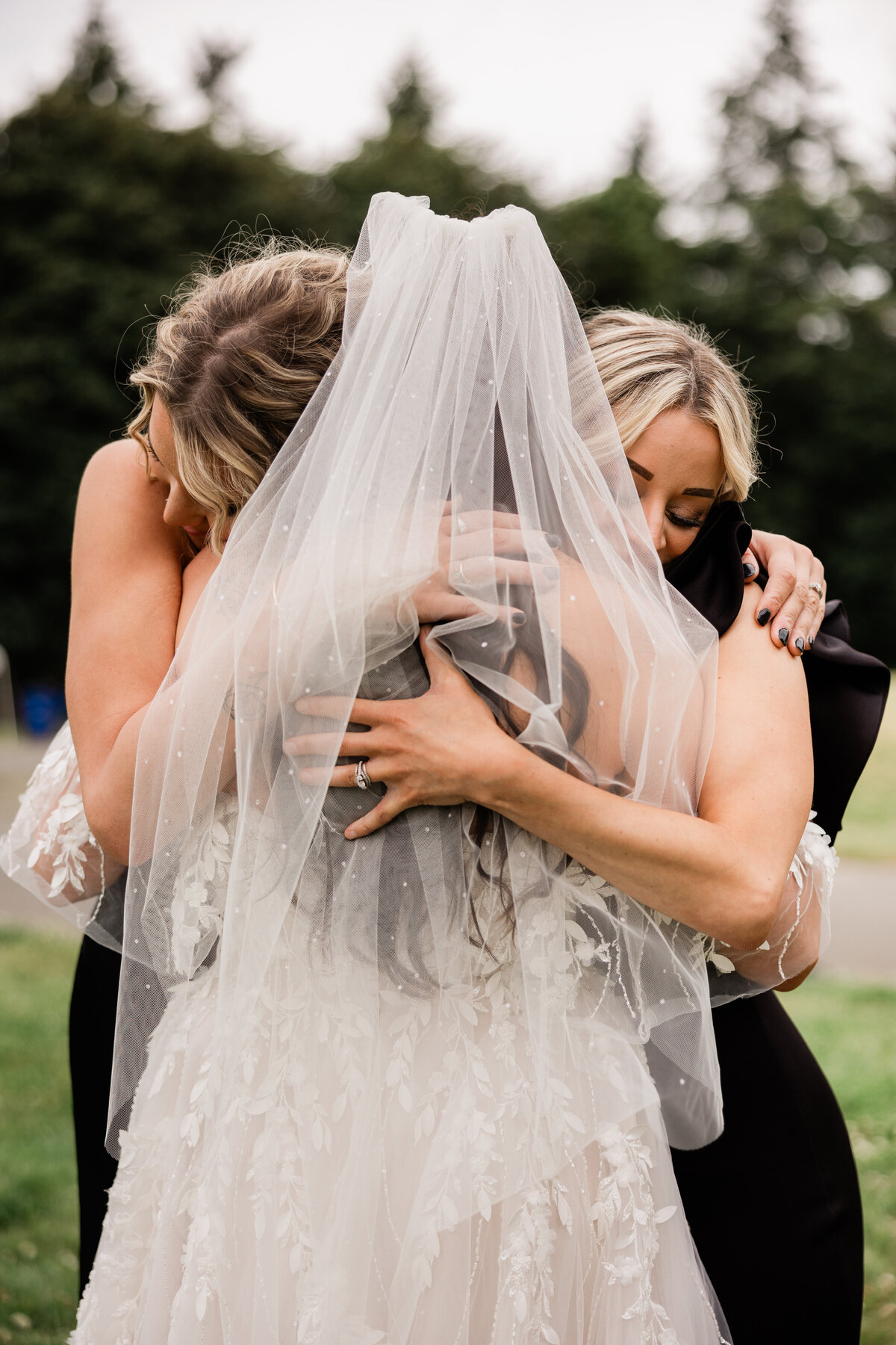 Bride hugging her bridesmaids