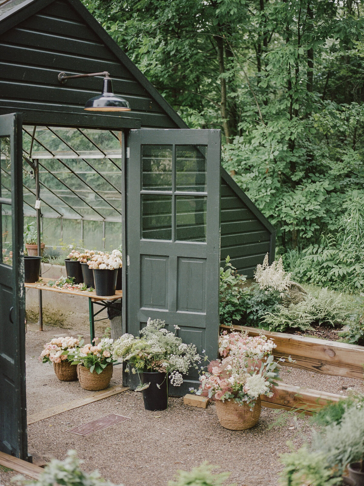 flowers in buckets outside the greenhouse at Glass House wedding venue, Michigan