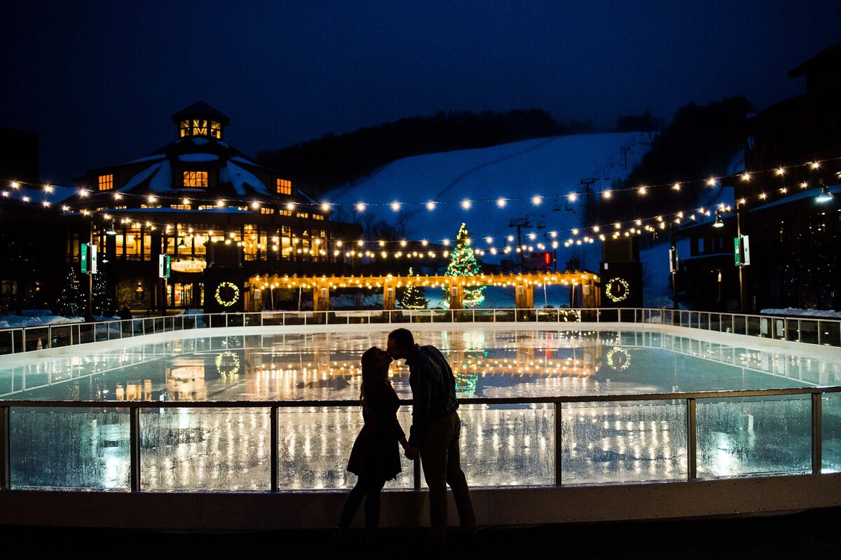 christmas light engagement session at the ice skating rink at spruce peak lodge in stowe