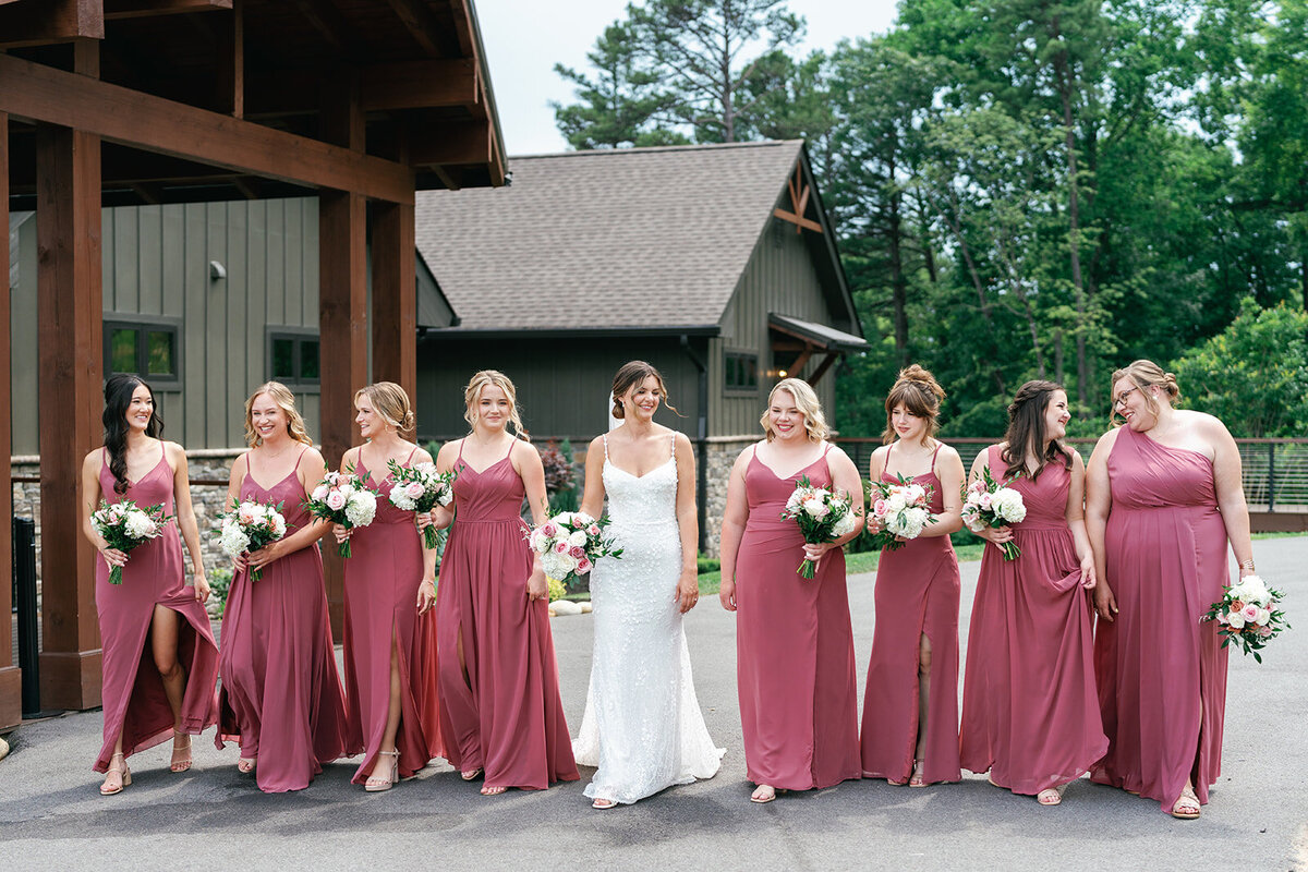 Bride and bridesmaids walking holding bouquets