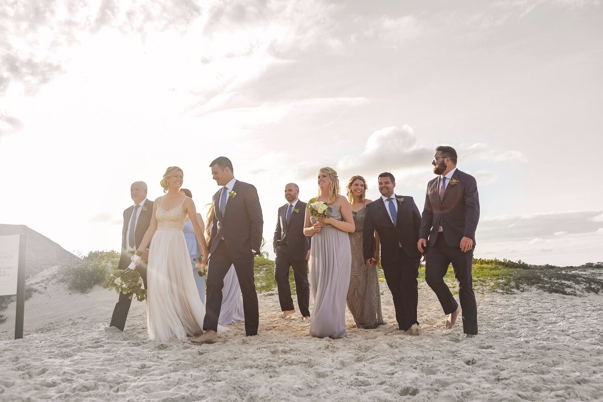 Bridal party walking together on beach in Cancun