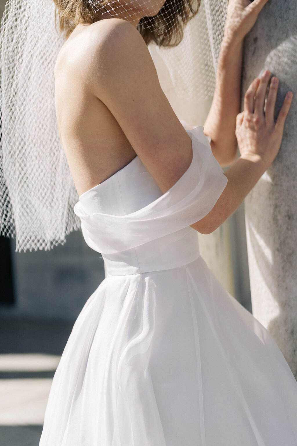 close up of off the shoulder wedding dress