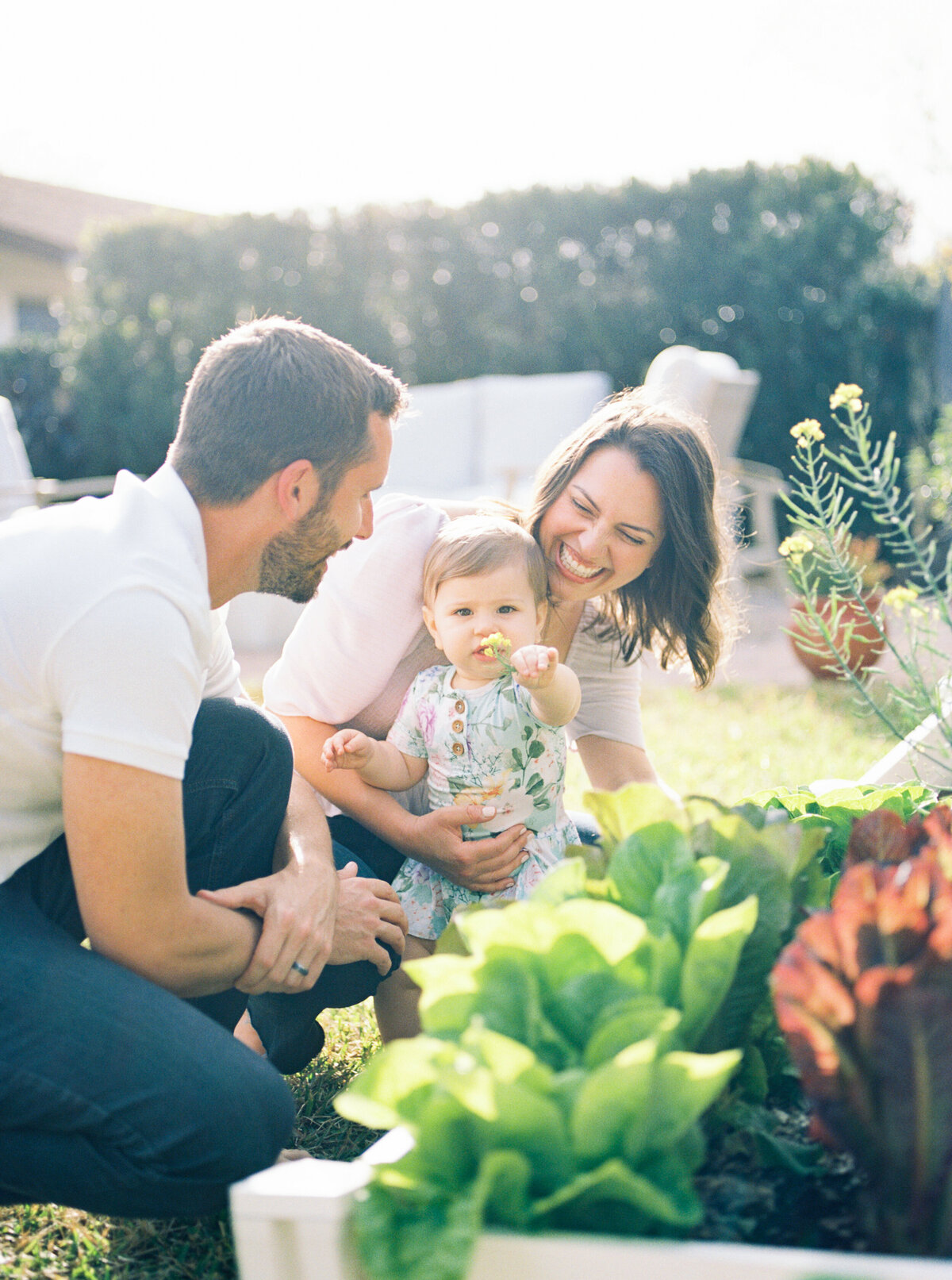 family with baby in the backyard garden with Orlando lifestyle photographer