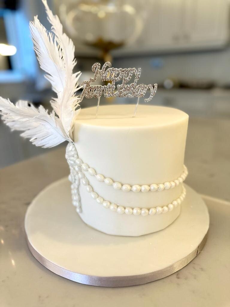 Pearl birthday cake with wafer paper feathers