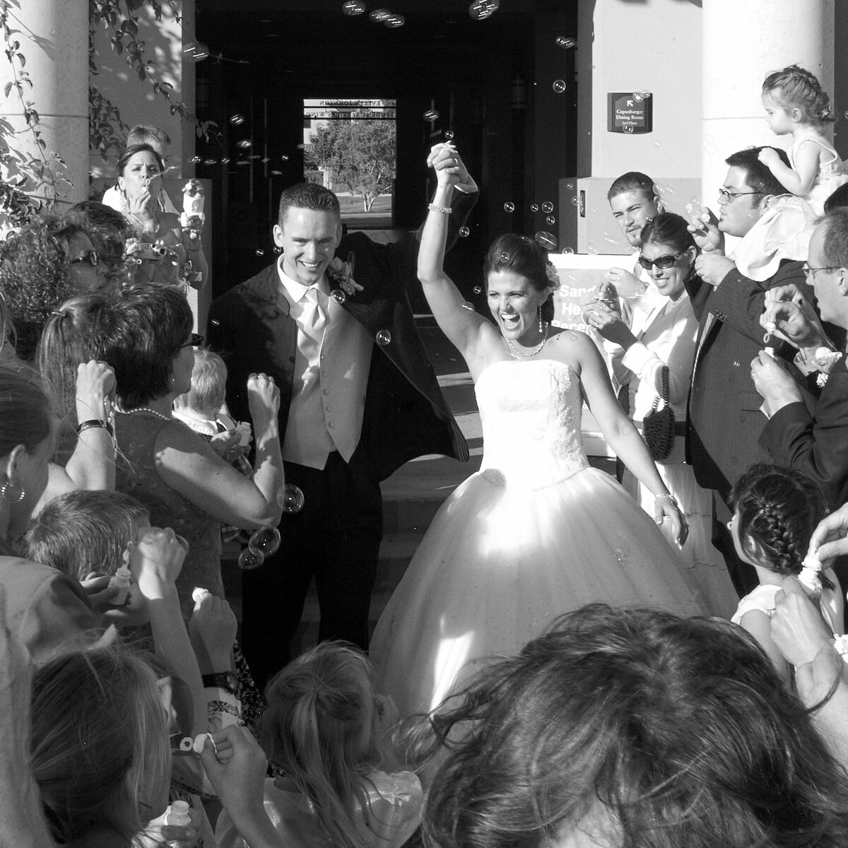 Bride and groom exiting their wedding ceremony triumphantly
