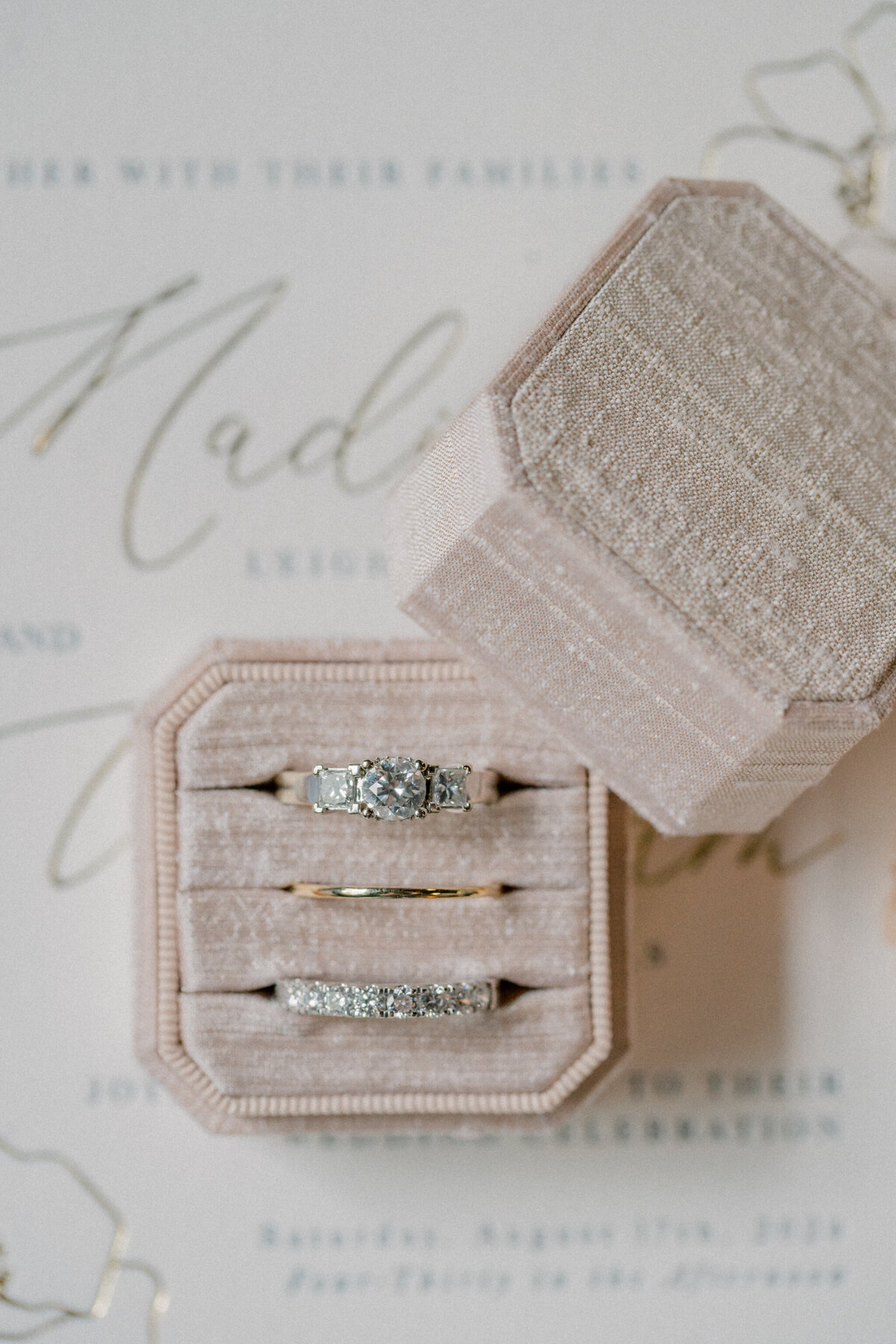 Wedding rings on white invitation at the Bristol Train Station