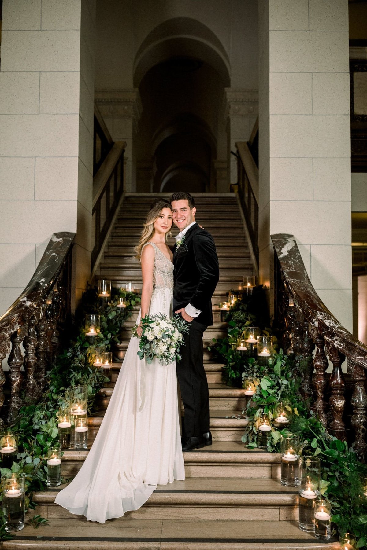 Bride and Groom pose together on a decorated staircase at The Majestic in Los Angeles