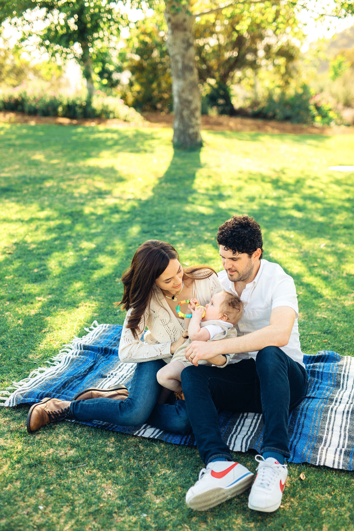 Family Portrait Photo Of Couple Holding Their Baby Who's Biting a Teether Los Angeles