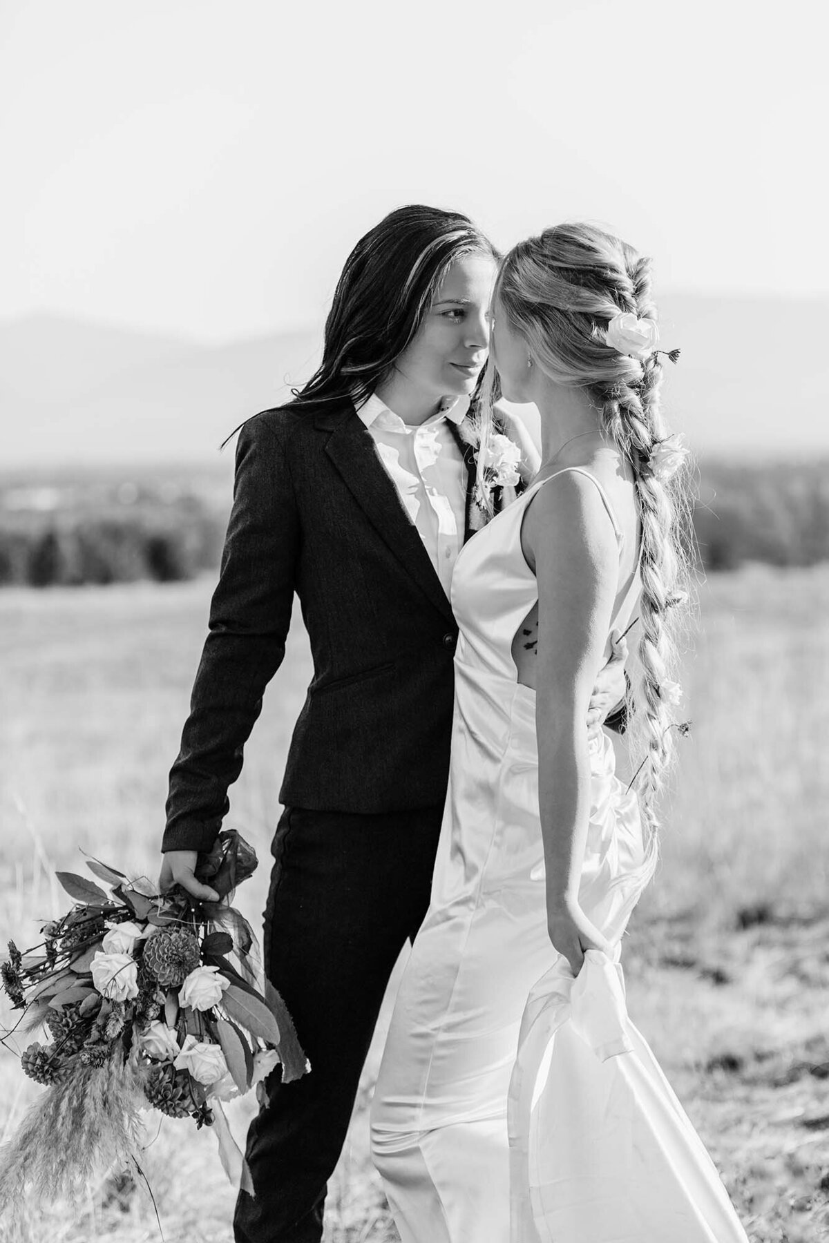 Missoula same sex couple embracing on wedding day, Blue Mountain, Missoula