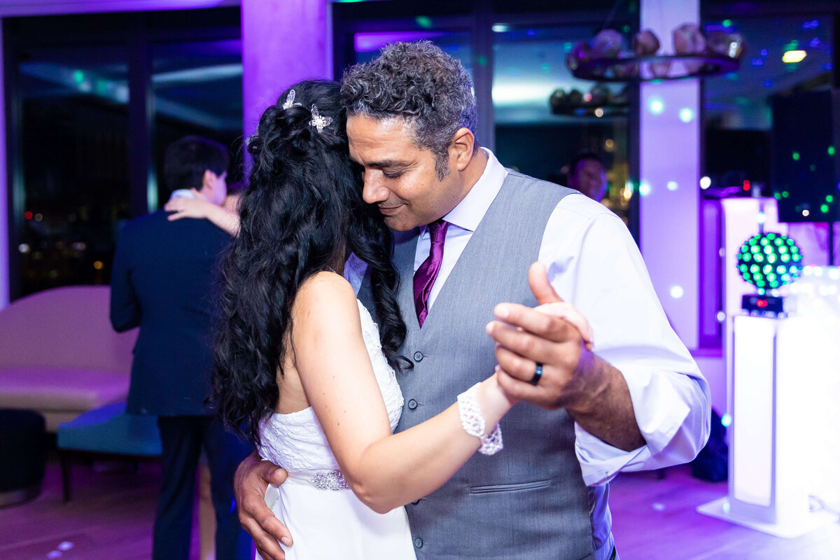 Bride and groom dancing with purple lights at wedding reception at The Aertson hotel, Nashville