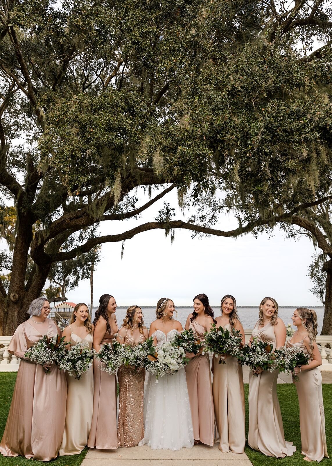 Bride with Bridesmaids on terrace overlooking water at Bella Cosa, Lake Wales, Florida