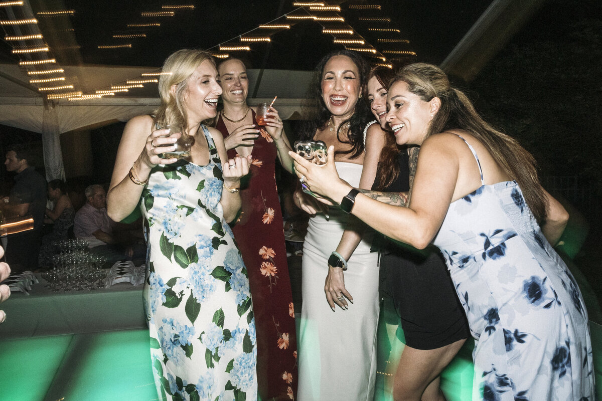Photo of smiling guests on neon green dance floor in private backyard party by Mira Park Photography NY based wedding photographer