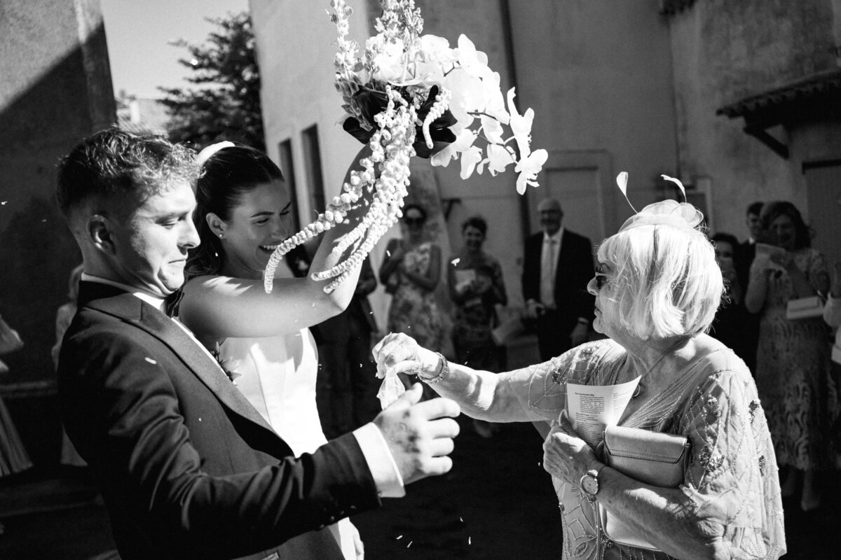 bride-church-exit-white-orchid-wedding-bouquet-france5