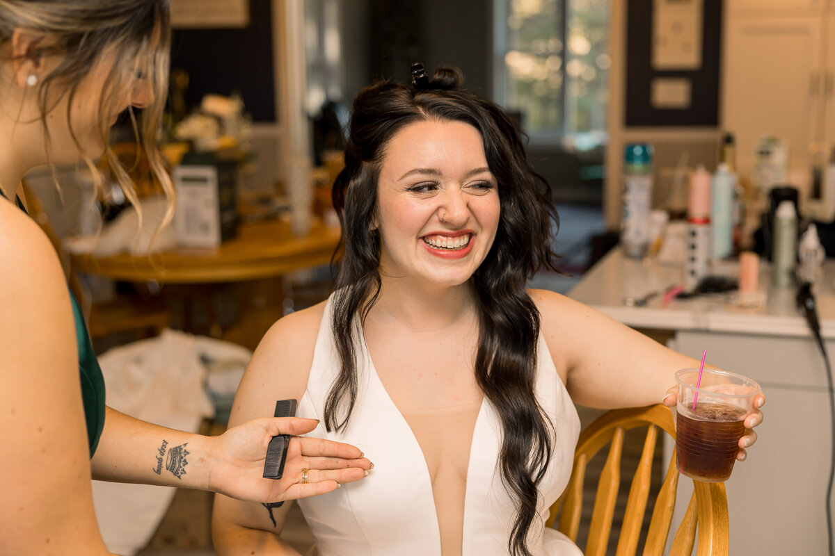 Bride getting ready for her wedding day at wedding in MN. Hair cut after the reception.