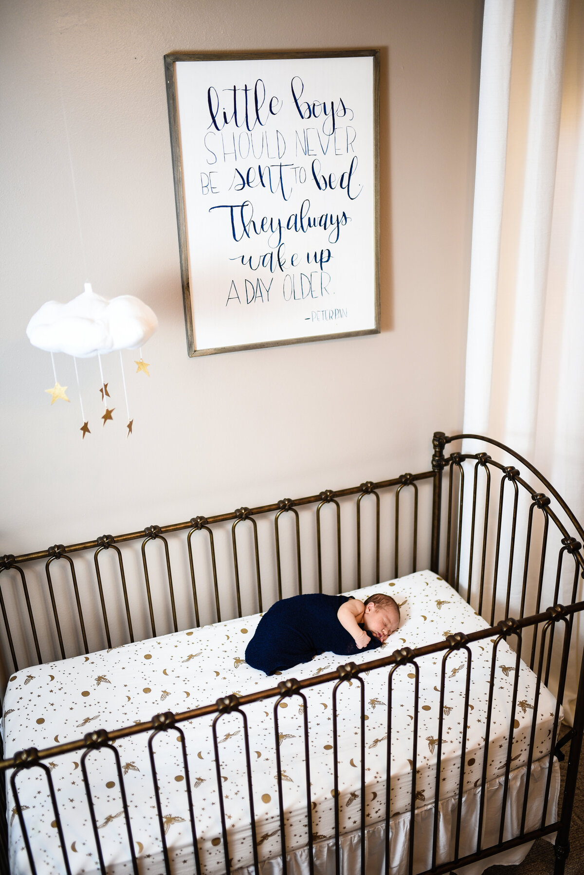 Beautiful lifestyle newborn photography: Newborn boy in his crib in his nursery in Mississippi
