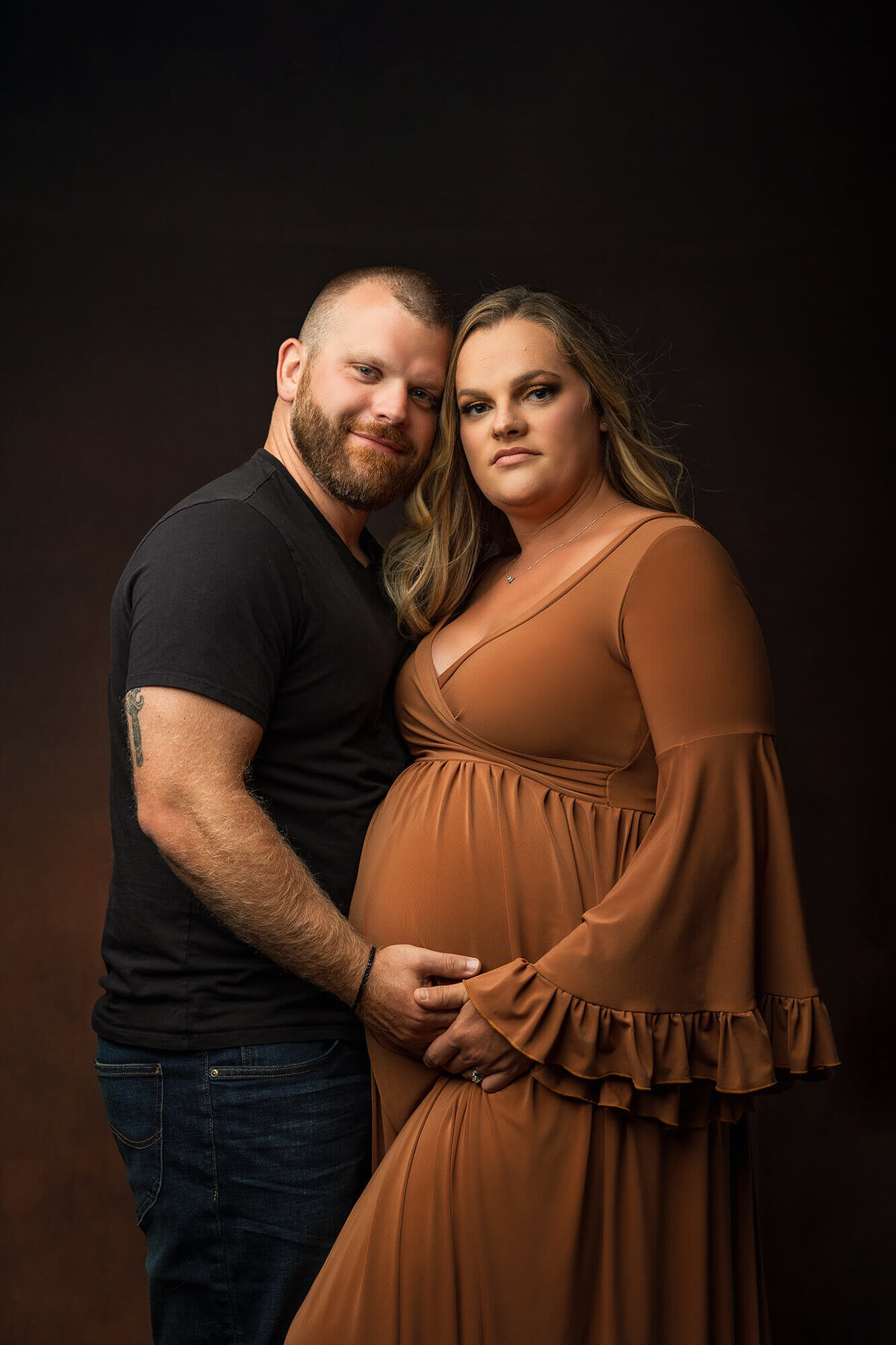 Expecting parents pose during their luxury photo session in Southern Minnesota.