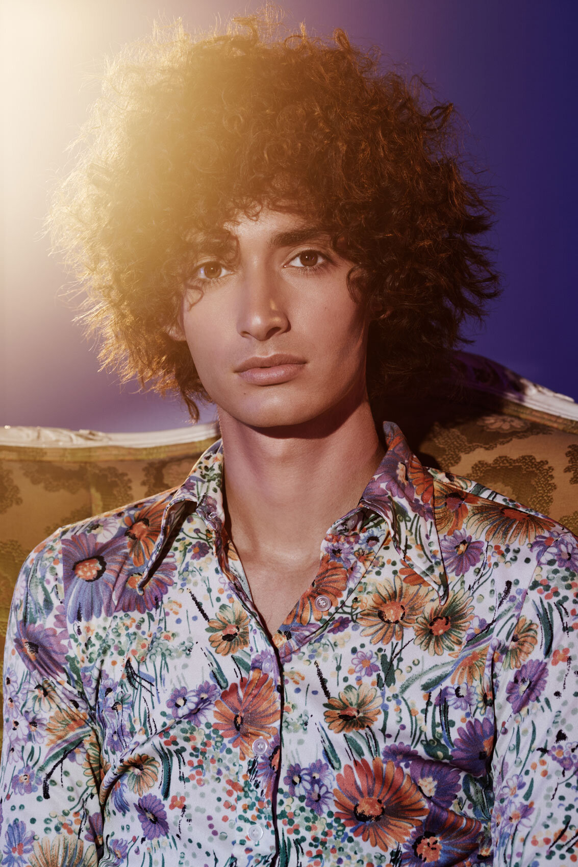 Colorful portrait of Seb Mahal wearing a floral shirt, captured in a vibrant studio setting by Ylva Erevall.