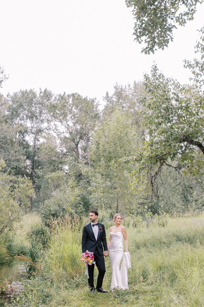 portrait of bride and groom at the Hudson bay arches during their Alberta wedding photographed by Calgary wedding photographer team Heidrich Photography