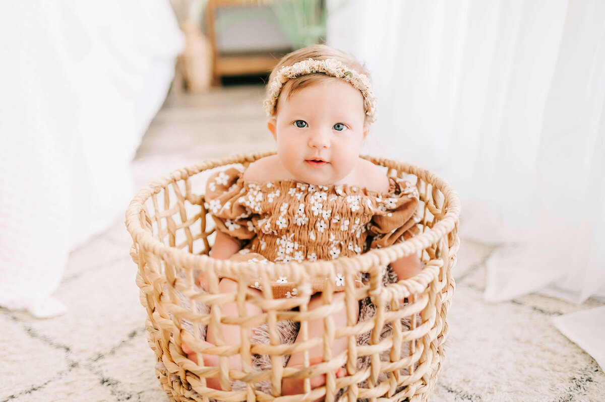 milestone baby picture in Branson MO of baby sitting in basket