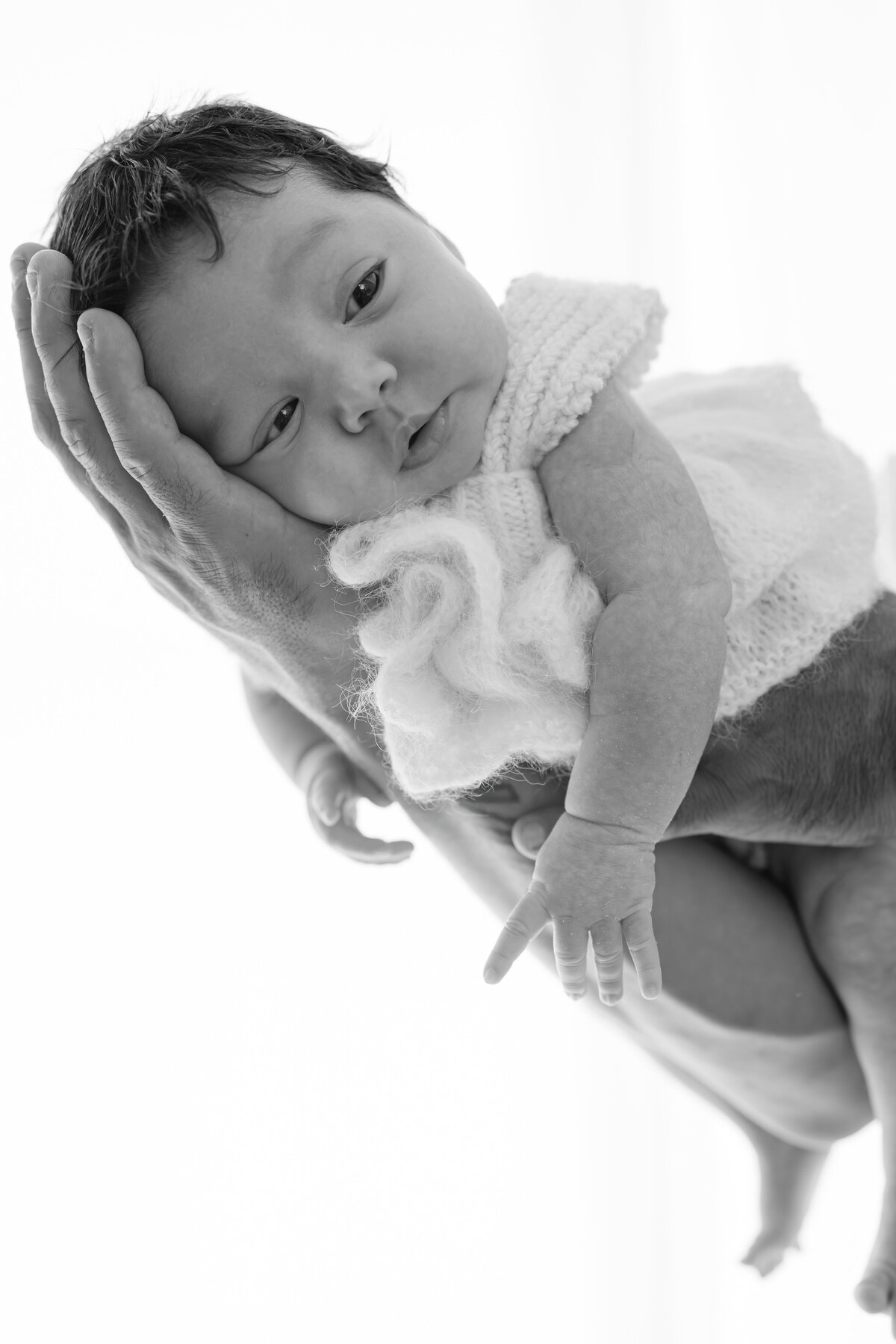 Baby in hand during natural light Barrie newborn photography session 
