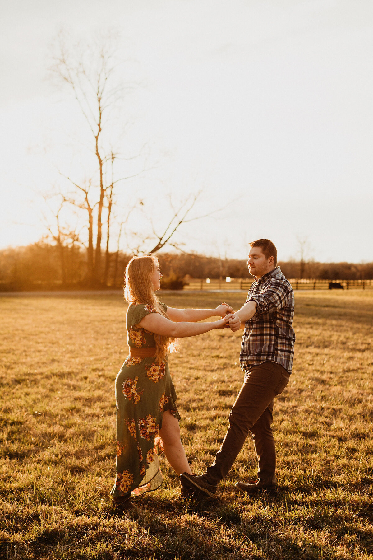 couple dancing on the lawn at sunset