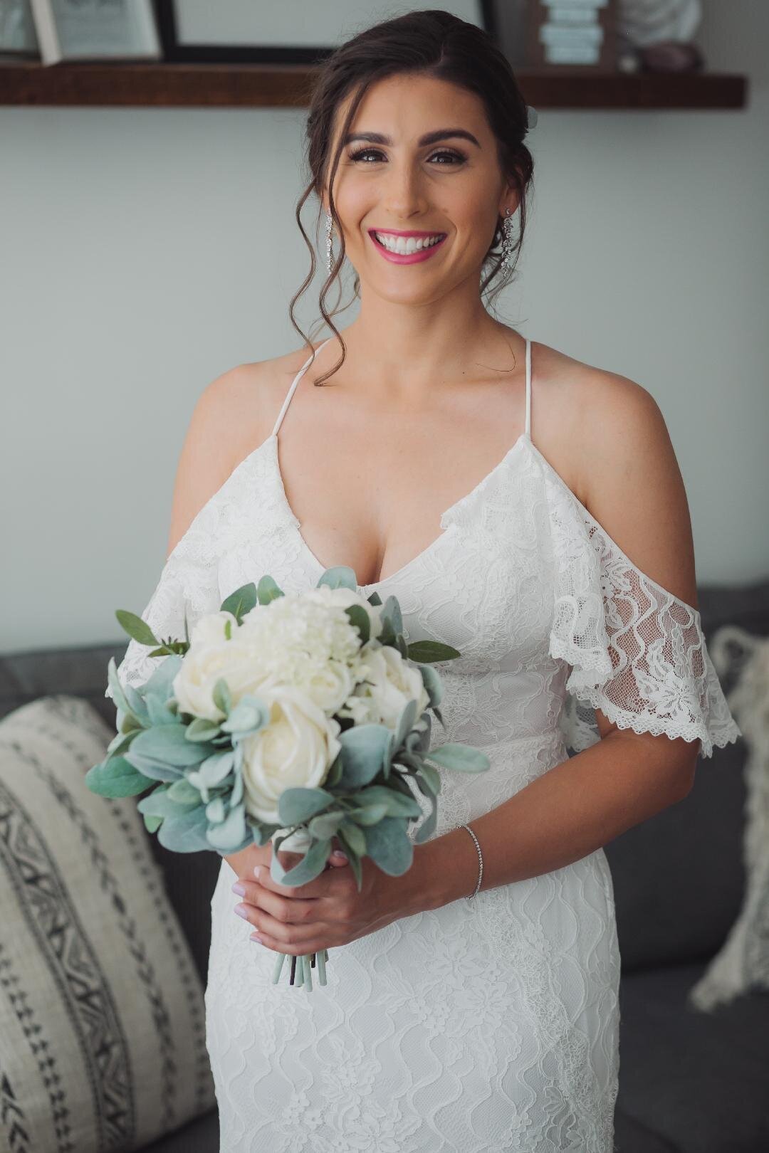 bride to be smiling with bouquet