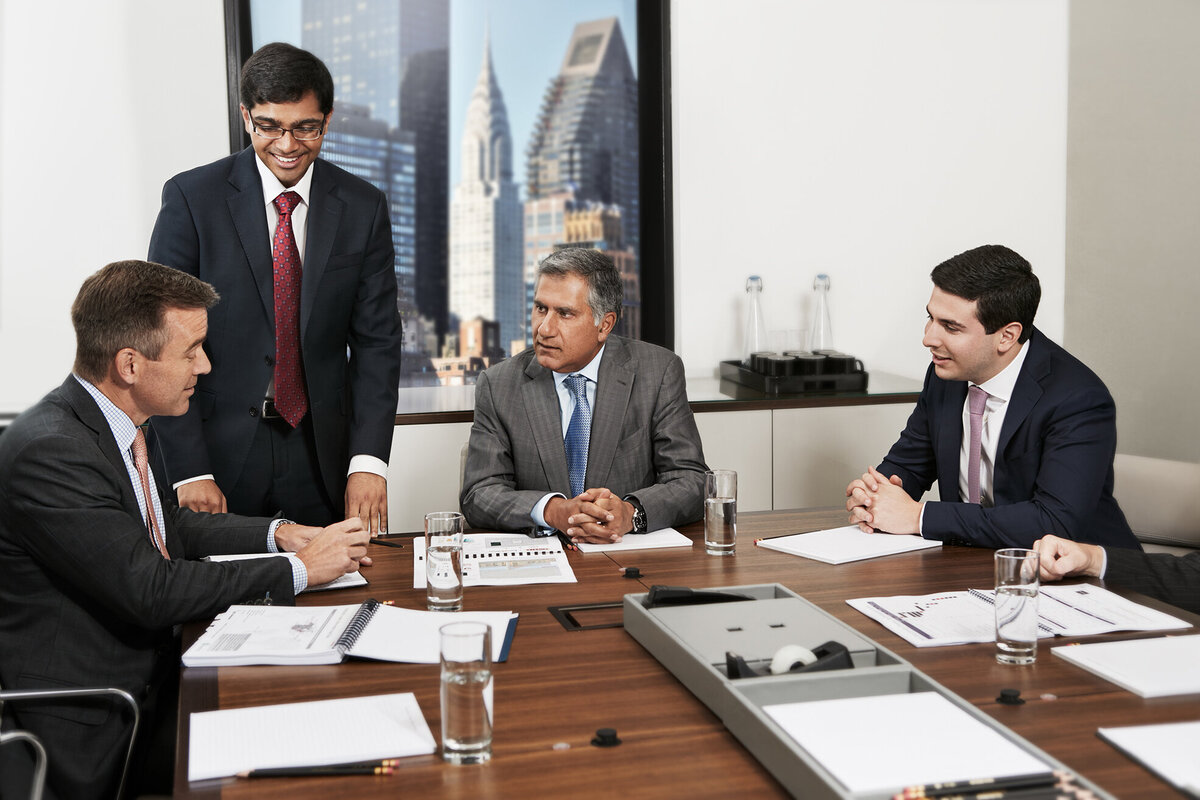 Professional meeting at Pheripas Capital with executives engaged in discussion around a conference table, captured by Ylva Erevall.