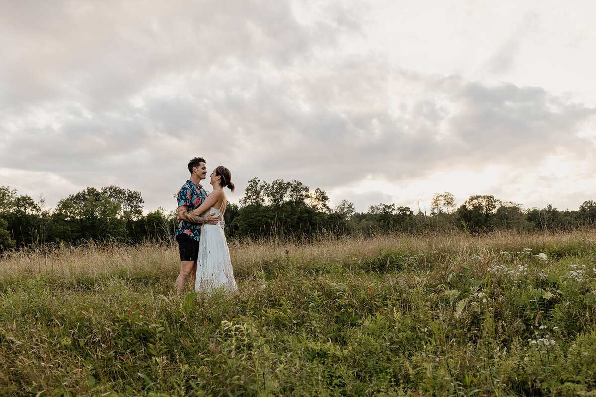 Newlyweds dancing in a field