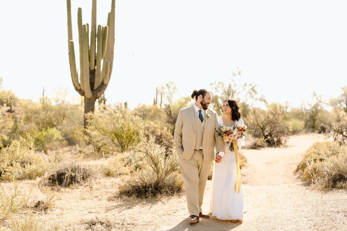 newlyweds walk in arizona landscape