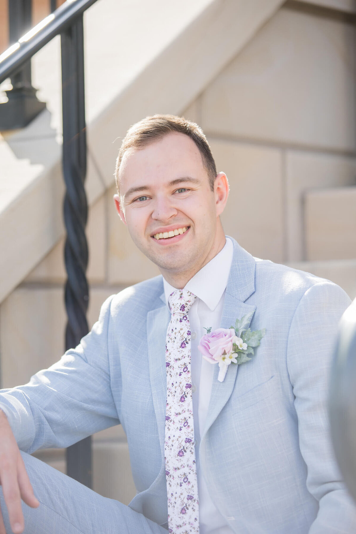 portrait of a groom in a light blue suit