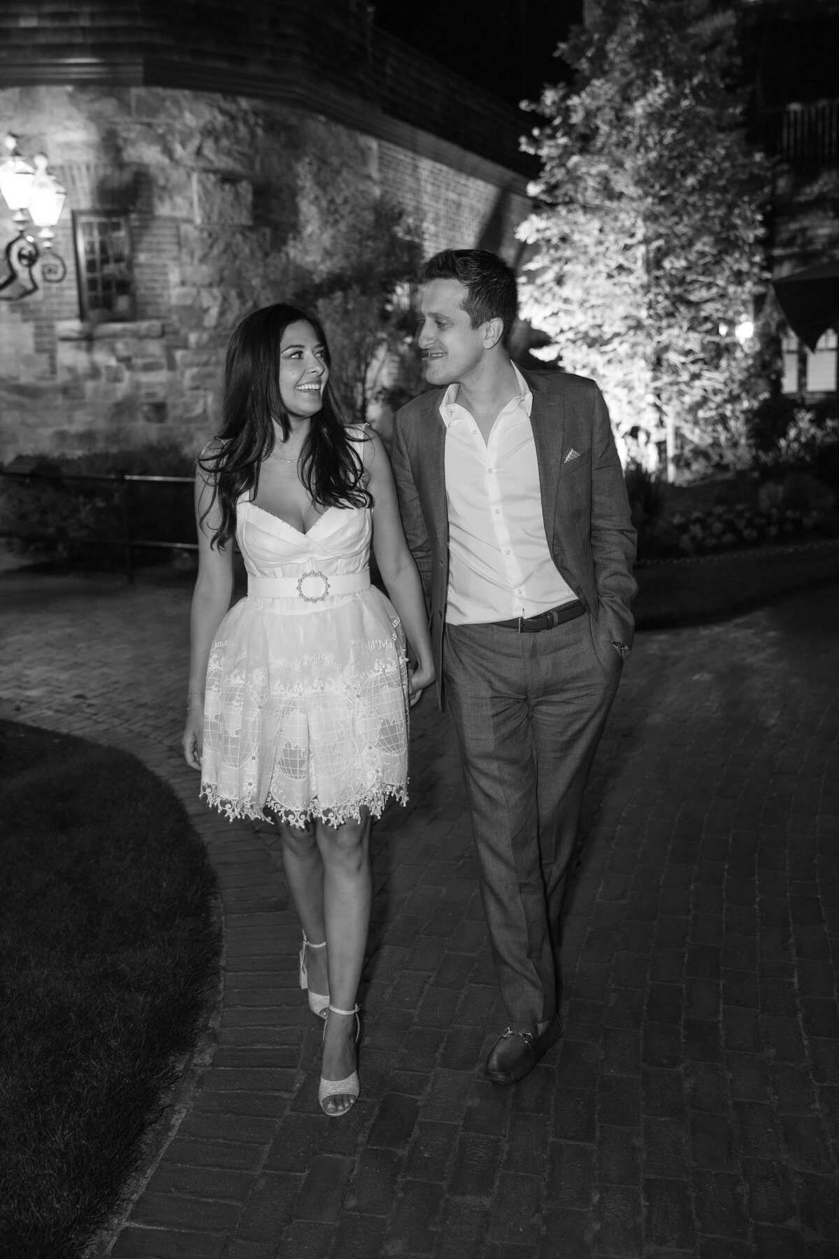 Couple walk hand in hand through the grounds of the Tennis Hall of Fame Newport Rhode Island.